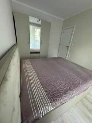 a bedroom with a bed and a large mirror at Lux City Apartment, free parking in Pazardzhik