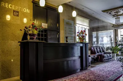 a salon with a reception desk in a room at Rubis Hotel in Rudozem