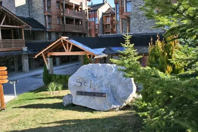 a large rock in front of a building at Apartment Saint Ivan Ski Resort in Bansko