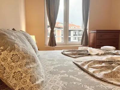 a bedroom with two beds and a window at Bojurland Apartment, Bansko in Bansko