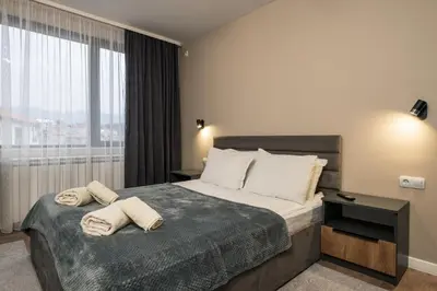 a hotel room with a bed with towels on it at City Apartments 4 in Velingrad
