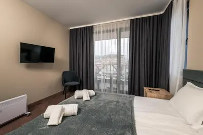 a hotel room with a bed and a window at City Apartments 4 in Velingrad