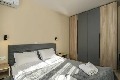 a bedroom with a bed with two towels on it at City Apartments 4 in Velingrad