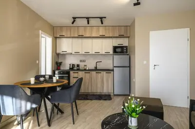 a kitchen and dining room with a table and chairs at City Apartments 4 in Velingrad
