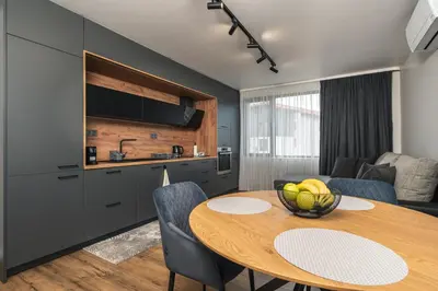 a kitchen and a table with a bowl of fruit on it at City Apartments 4 in Velingrad