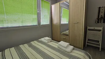a bedroom with a bed with two white towels on it at Cozy Boho small apartment in Sofia