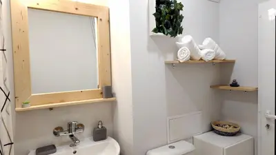 a bathroom with a toilet and a sink and a mirror at Cozy Boho small apartment in Sofia