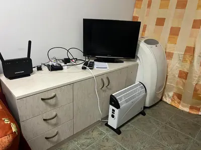 a desk with a computer and a printer and a tv at Cheep&Free on the Ground floor and Pets friendly in Sofia