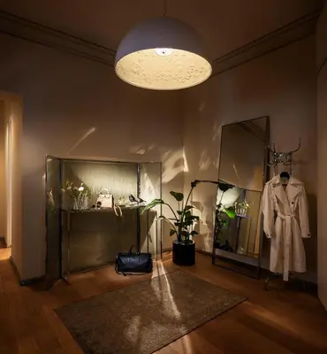 a room with a display case and a coat on a mannequin at The Nest by Juno Hotel Sofia in Sofia