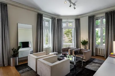 a living room with two couches and a tv at The Nest by Juno Hotel Sofia in Sofia