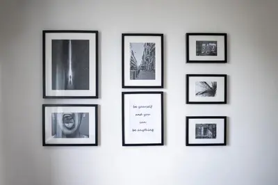 a group of framed pictures on a wall at Black Peak Panorama central apartment in Sofia