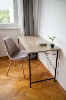 a wooden desk with a chair and a book at Black Peak Panorama central apartment in Sofia