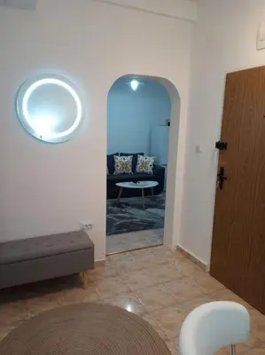 a living room with a couch and a mirror at Cathedral Central Apartment Top Location in Sofia