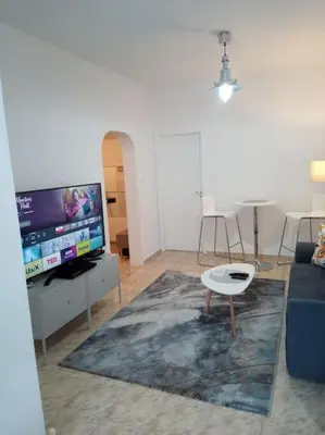 a living room with a couch and a tv at Cathedral Central Apartment Top Location in Sofia