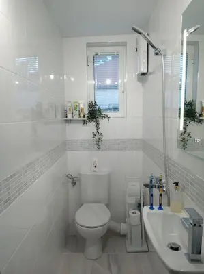 a white bathroom with a toilet and a sink at Cathedral Central Apartment Top Location in Sofia