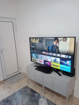 a flat screen tv sitting on top of a white cabinet at Cathedral Central Apartment Top Location in Sofia