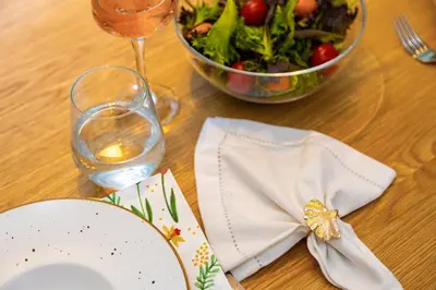 a table with a plate and a bowl of salad at Happy People Plovdiv 1-BD Apartment - White by Flat Mаnager in Plovdiv