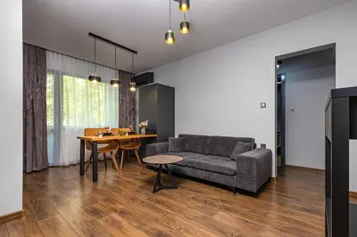 a living room with a couch and a table at Happy People Plovdiv - Grey 1-BD Apartment by Flat Mаnager in Plovdiv