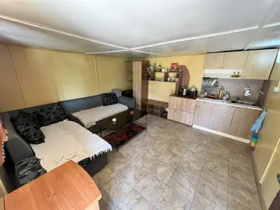 a living room with a couch and a kitchen at Cozy Quiet Retreat 70km from Sofia in Kyustendil