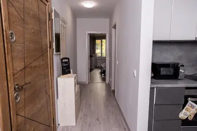 a hallway leading to a kitchen with a counter top at Cozy 1BR in Heart of Oborishte with Private Parking in Sofia