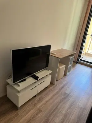 a living room with a large flat screen tv on a stand at Апартамент Клисура in Plovdiv