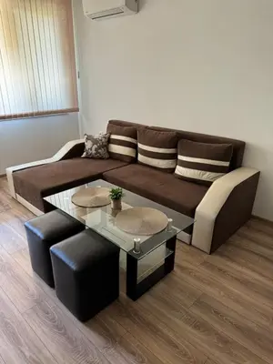 a living room with a couch and a table at Апартамент Клисура in Plovdiv