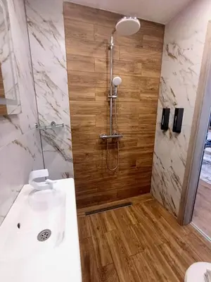 a bathroom with a shower and a white sink at Apartmenthaus Oborishte - 27 in Panagyurishte