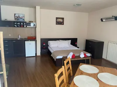 a bedroom with a bed and a table and chairs at Bansko Royal Towers APARTMENT 738 in Bansko