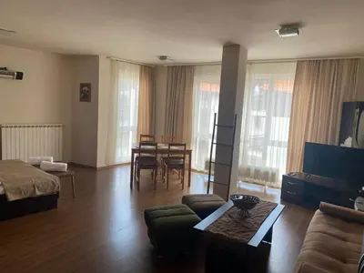 a living room with a couch and a table at Bansko Royal Towers APARTMENT 738 in Bansko