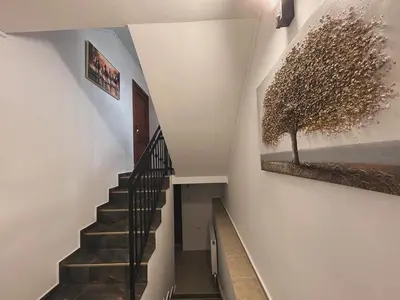 a staircase in a house with a painting on the wall at Къща Цвети in Dobrinishte
