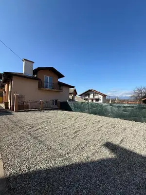 a house sitting on top of a gravel driveway at Къща Цвети in Dobrinishte
