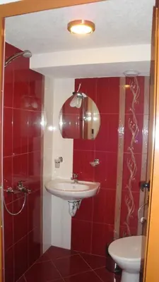 a bathroom with a sink and a toilet at Дамянова Къща in Dobrinishte