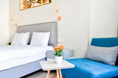 a bedroom with a blue bed and a blue chair at Prime Spot for 5 Full Kitchen Wi-Fi AC in Sofia