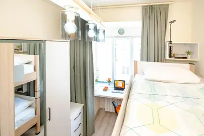 a small bedroom with a bed and a desk at 2BR Downtown Suit Next to Nevski Cathedral - AC in Sofia