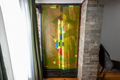 a stained glass window on a brick fireplace at Къща за гости Приказка in Klisura
