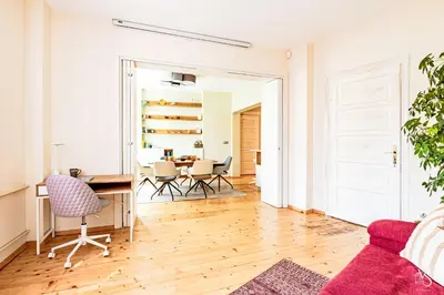 a living room with a table and chairs at Luxury And Spacious Apartment at the Hearth of the City in Sofia