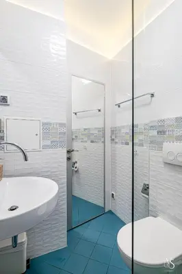 a white bathroom with a sink and a shower at Luxury And Spacious Apartment at the Hearth of the City in Sofia