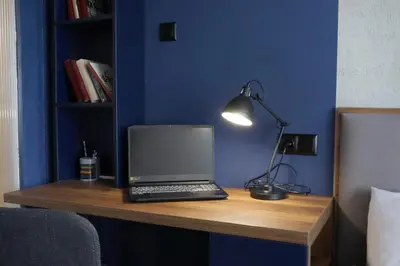 a laptop computer sitting on top of a wooden desk at NEW The Blue Heart Of Sofia Center in Sofia