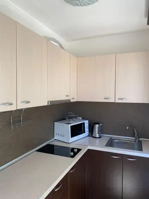 a kitchen with a microwave and a sink at Hill Top Studio Apartments in Bansko