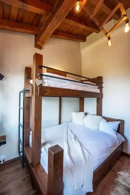 a bedroom with a bunk bed with white sheets at The Chalet 2 Bedrooms Paradise in Bansko