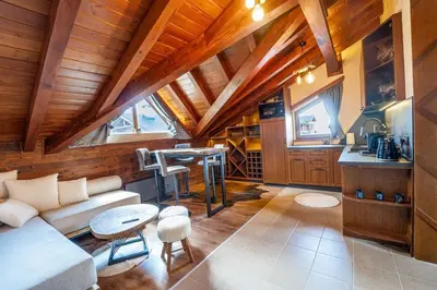 a living room with a couch and a table at The Chalet 2 Bedrooms Paradise in Bansko