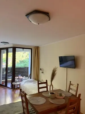a room with a table and a bed and a dining room at Николай Желев-Първи ЕООД in Pamporovo