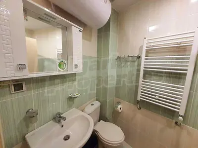 a bathroom with a sink and a toilet and a mirror at Студио в Хотел Айсберг in Borovets