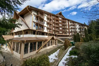 a large apartment building with a roof at Студио в Хотел Айсберг in Borovets