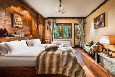 a bedroom with a bed with a blanket on it at Mountain Villa Borovets in Borovets