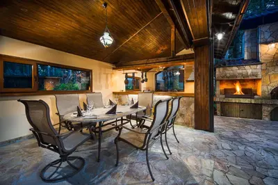 a dining room with a table and chairs and a fireplace at Mountain Villa Borovets in Borovets