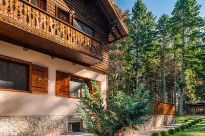 a house with a balcony on the side of it at Mountain Villa Borovets in Borovets
