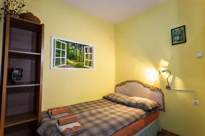 a bedroom with a bed and a window at Residence Art Guest House in Plovdiv