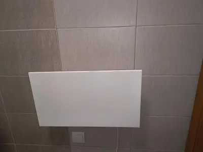 a white sign on a tiled wall in a bathroom at Апартамент за гости Александър in Chepelare