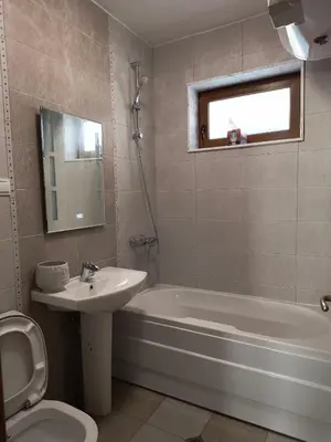 a bathroom with a sink and a tub and a toilet at Апартамент за гости Александър in Chepelare